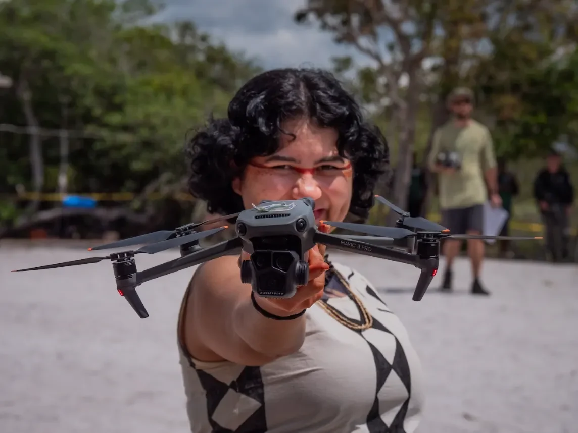 Marina Mura holding a survey drone during fieldwork in the Amazon